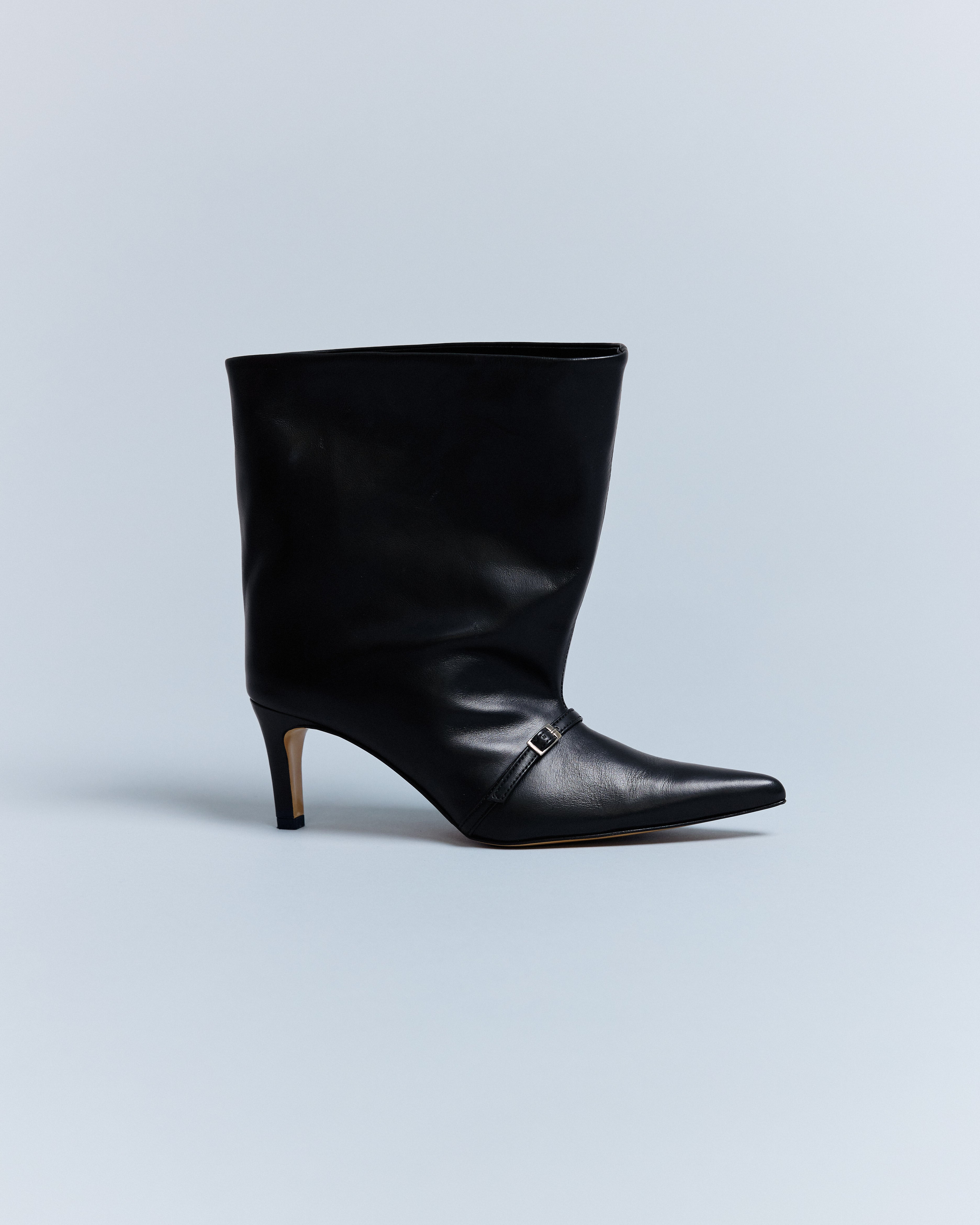 A black leather boot with a pointed toe and buckle strap, on a plain background.