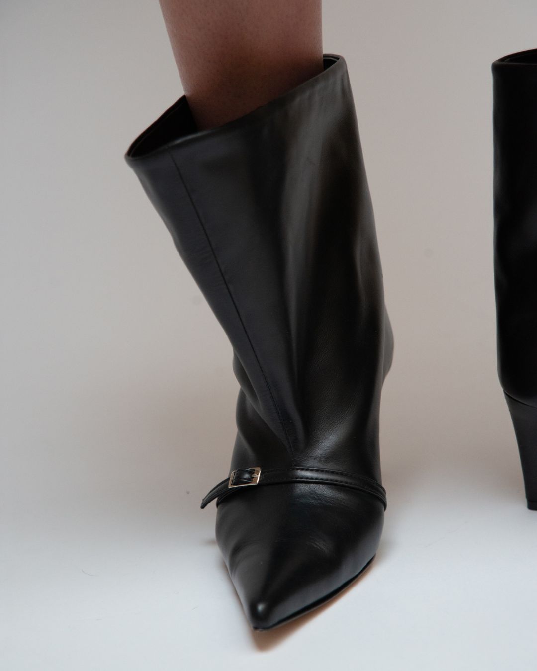 KALDA  black leather boot with a pointed toe and a buckle strap
