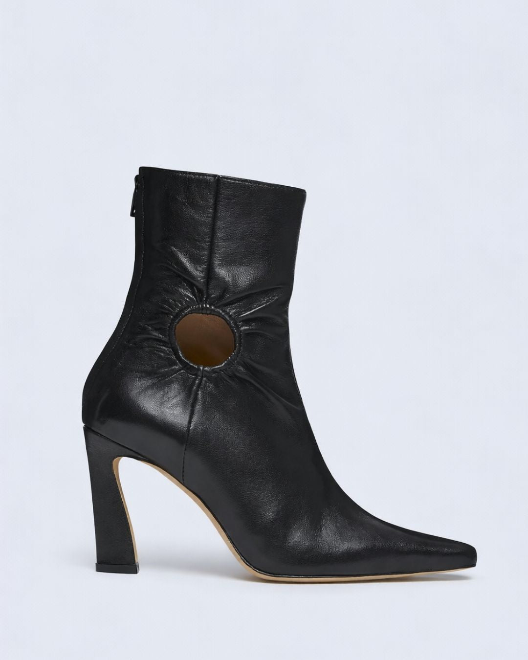 KALDA black leather ankle boot with a cut out design on a light gray background