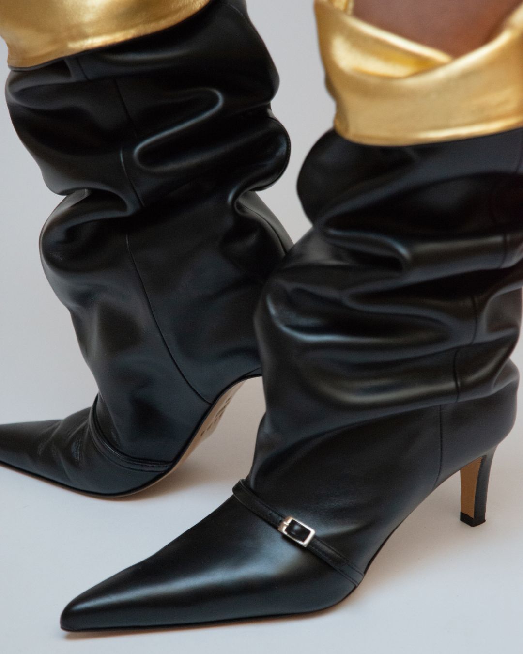 KALDA black leather boots with gold detailing close up