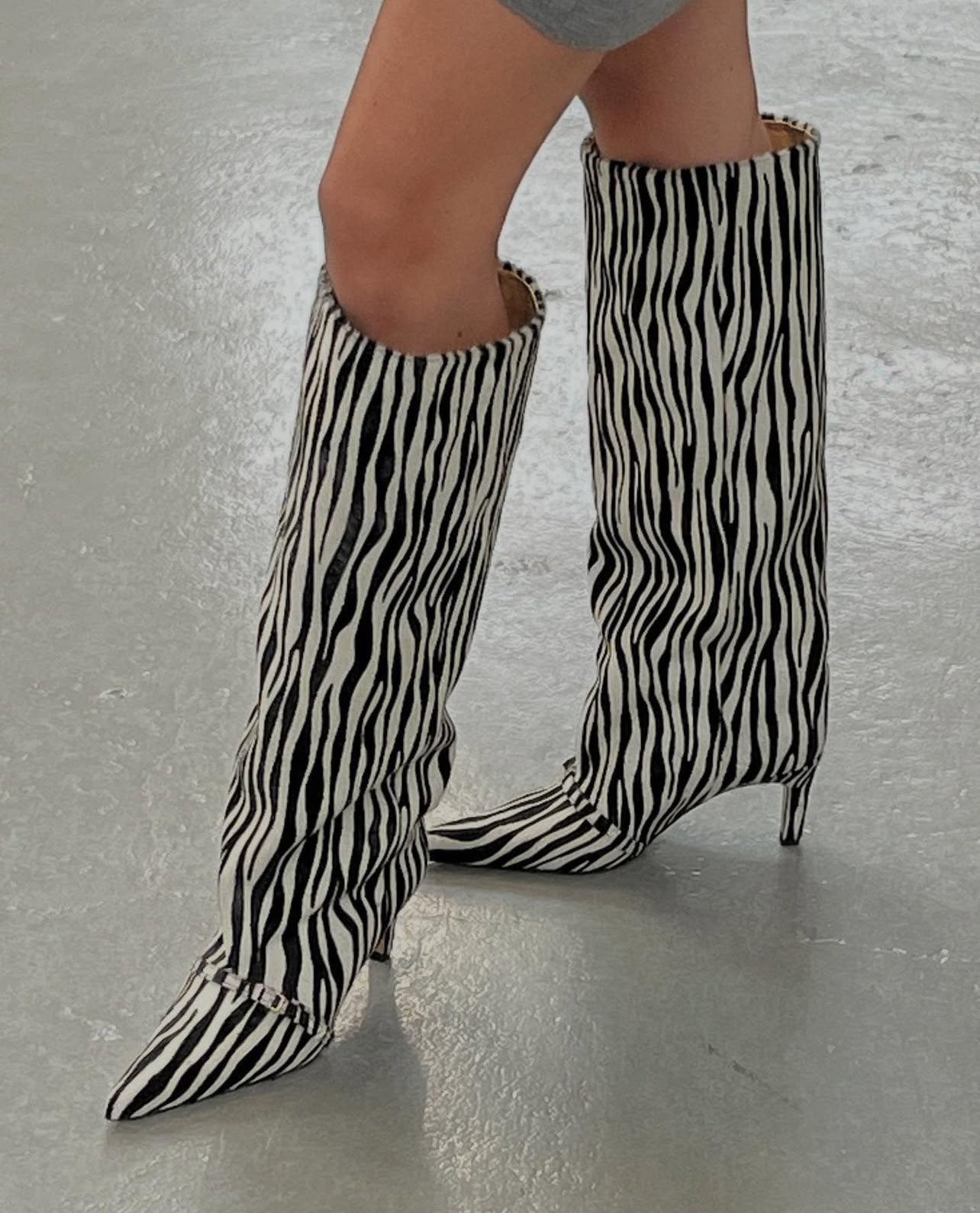 KALDA Zebra-striped knee-high boots on a neutral background