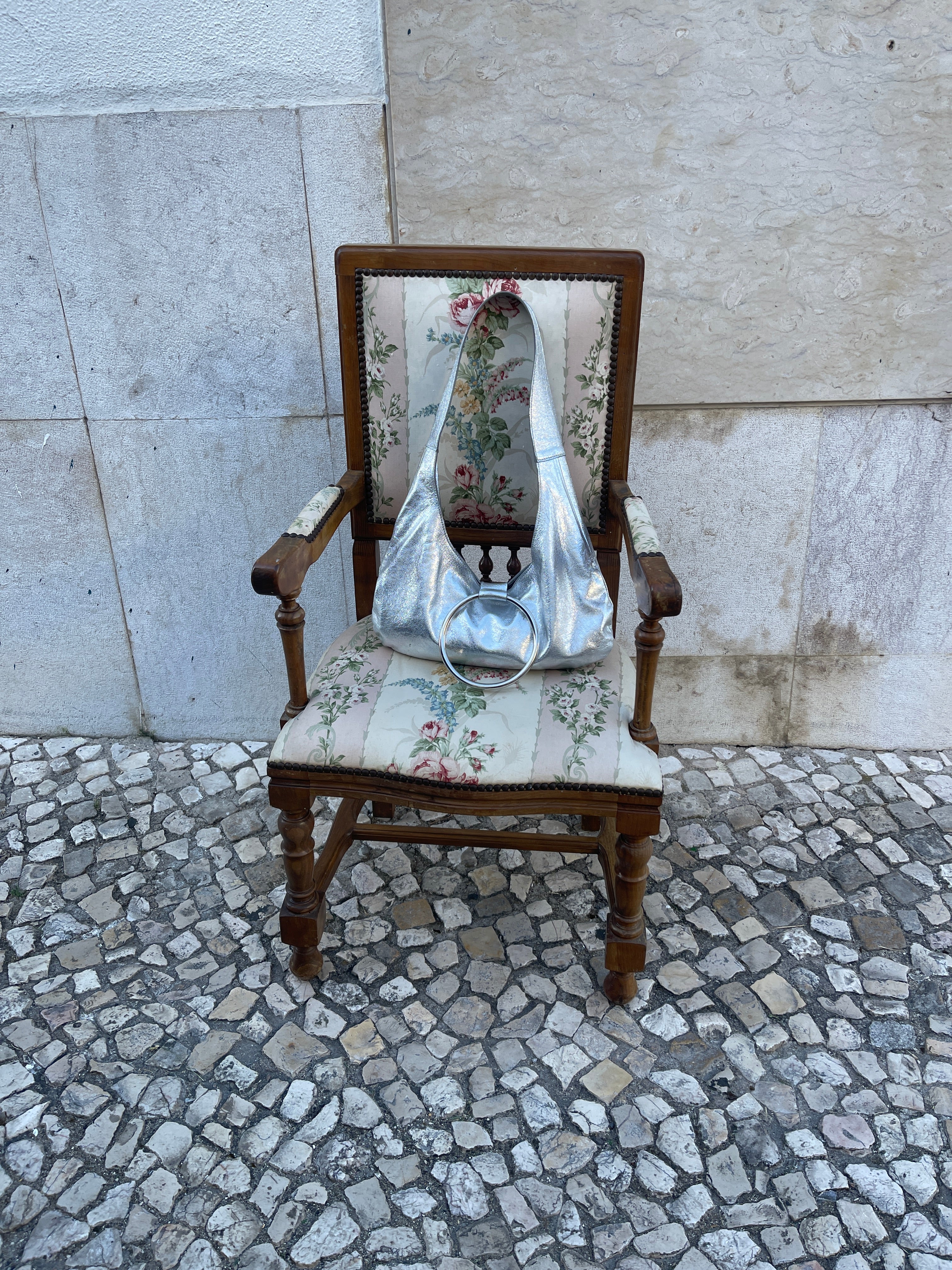 KALDA silver bag on a vintage wooden chair 