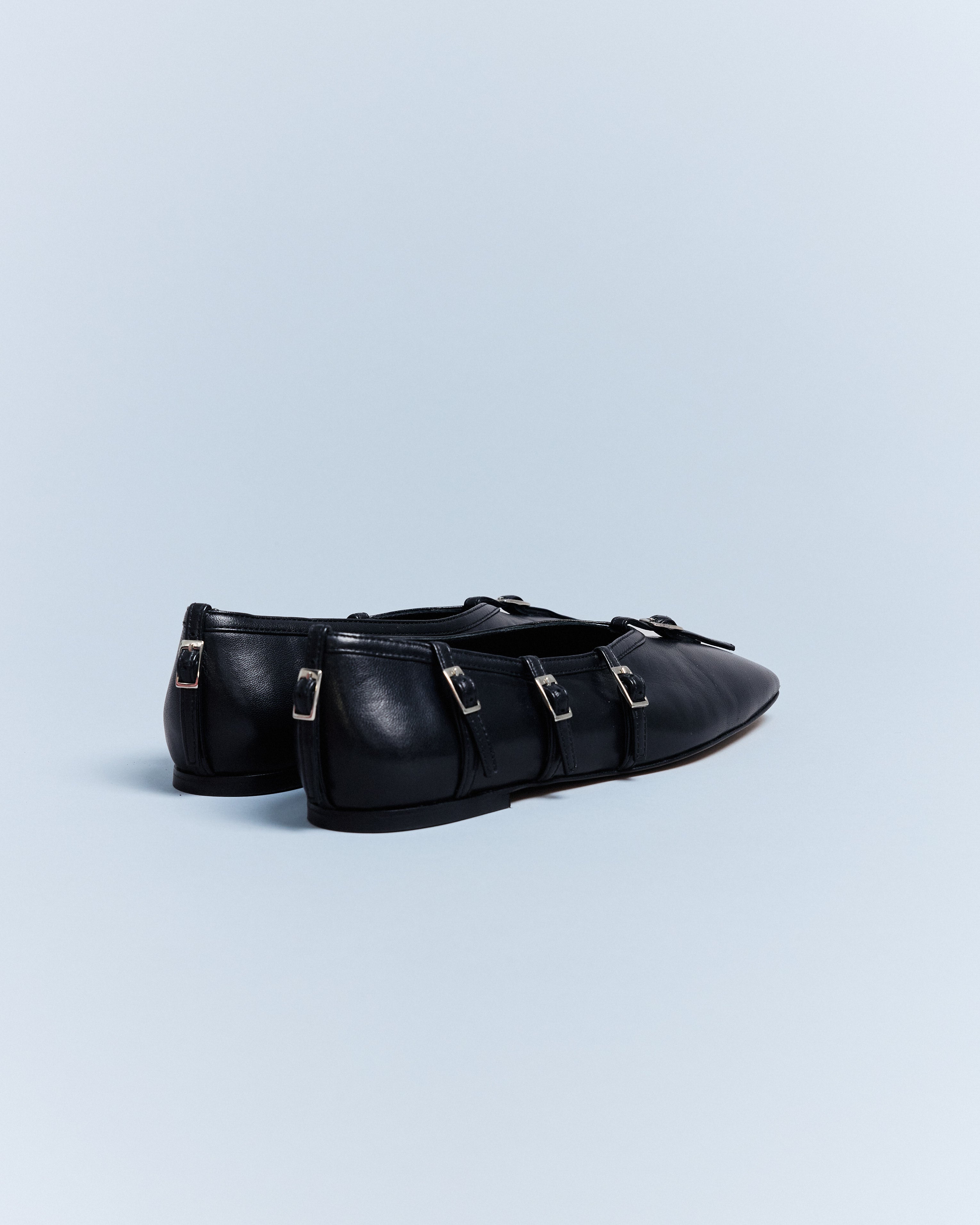 KALDA black leather flat with buckle straps, back view