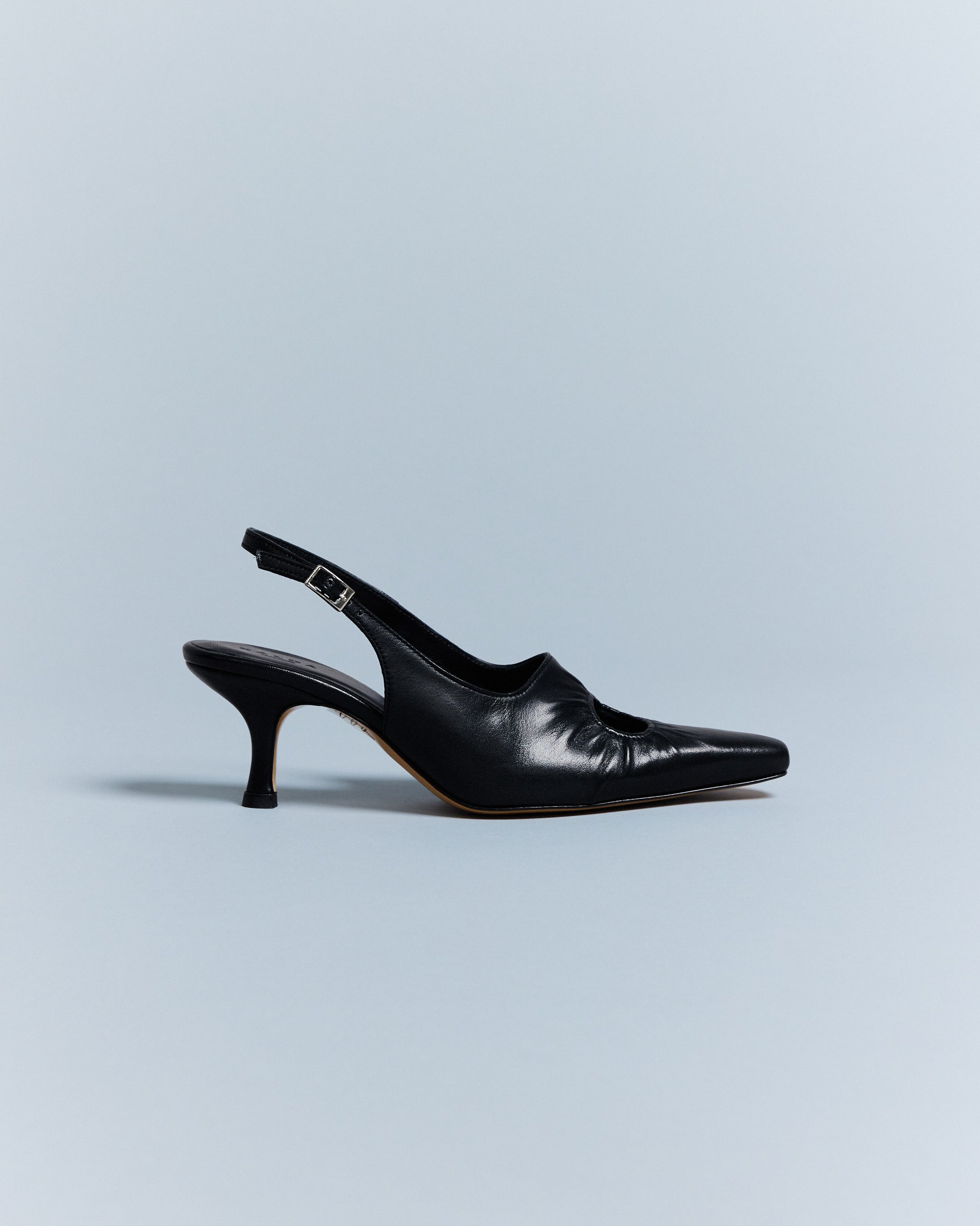KALDA single black leather heel with a visible toe cleavage due to a circle cut-out design.