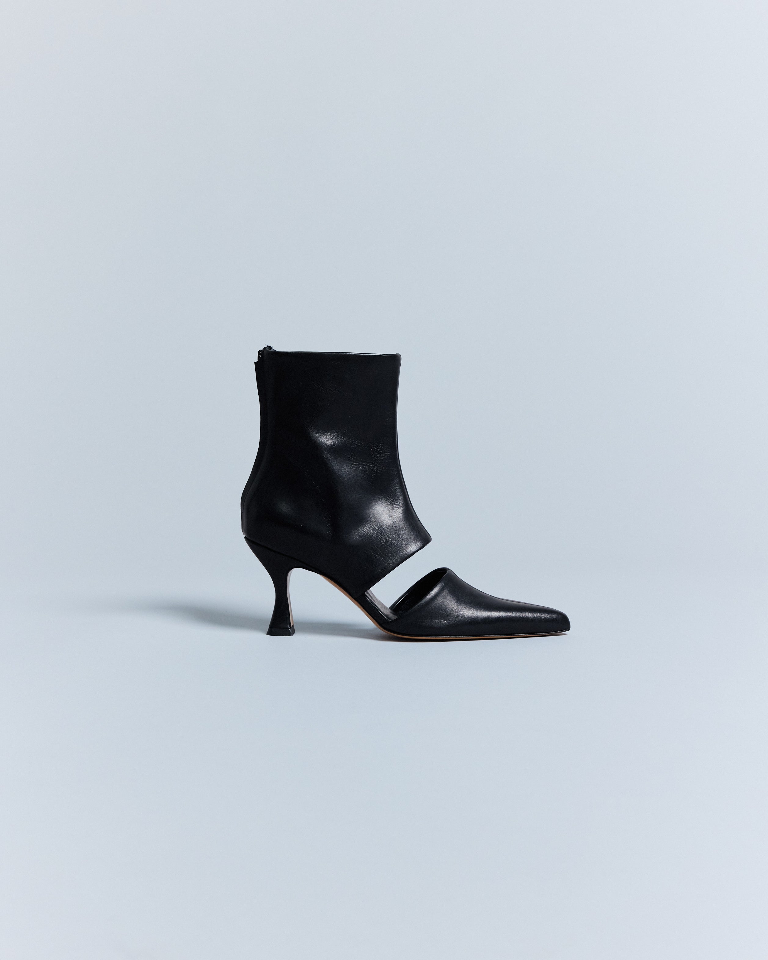 KALDA black leather ankle boot with a pointy toe and a signature cut out, displayed against a neutral background.