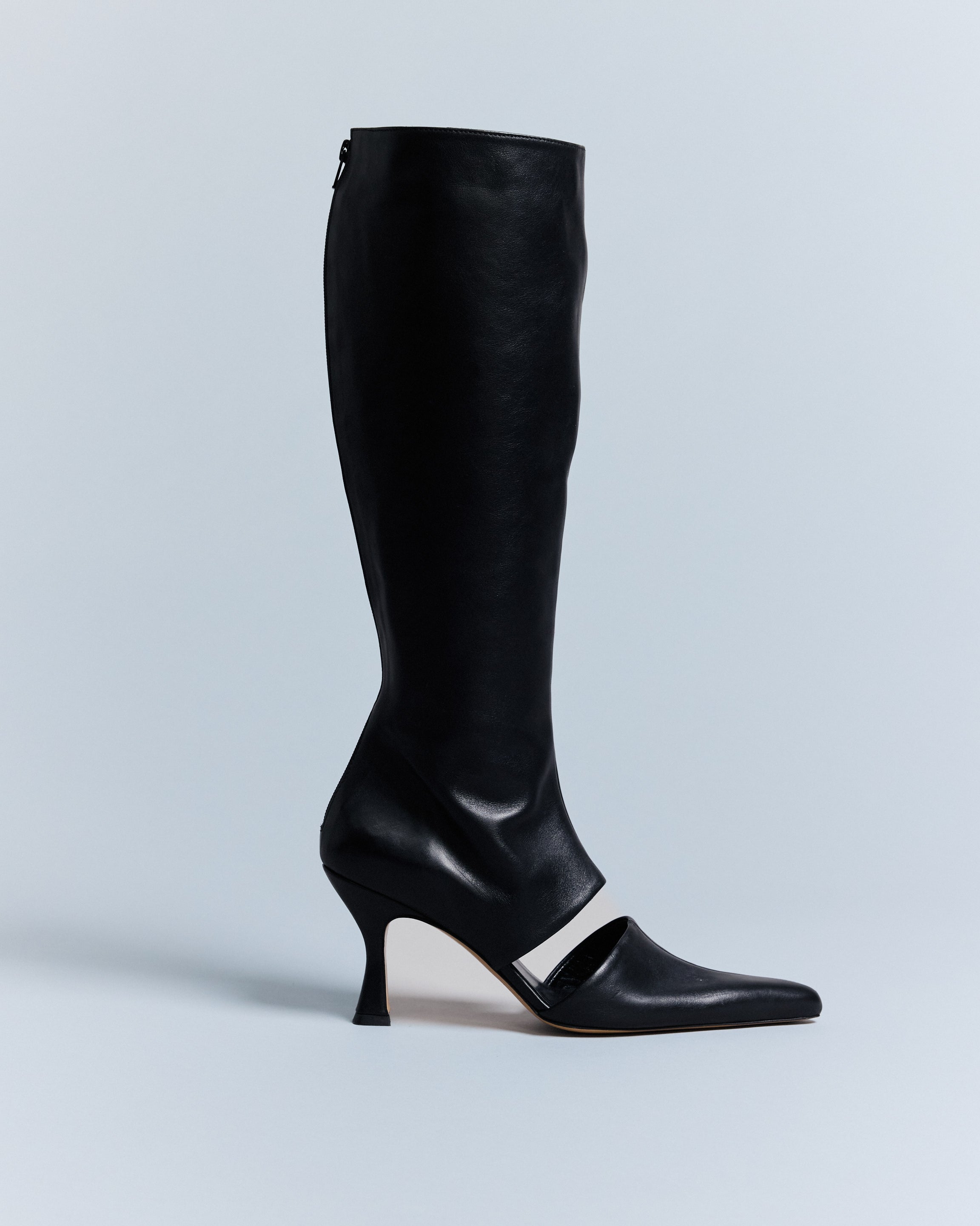KALDA black knee-high boot with a cut out detail and a pointed toe. side view