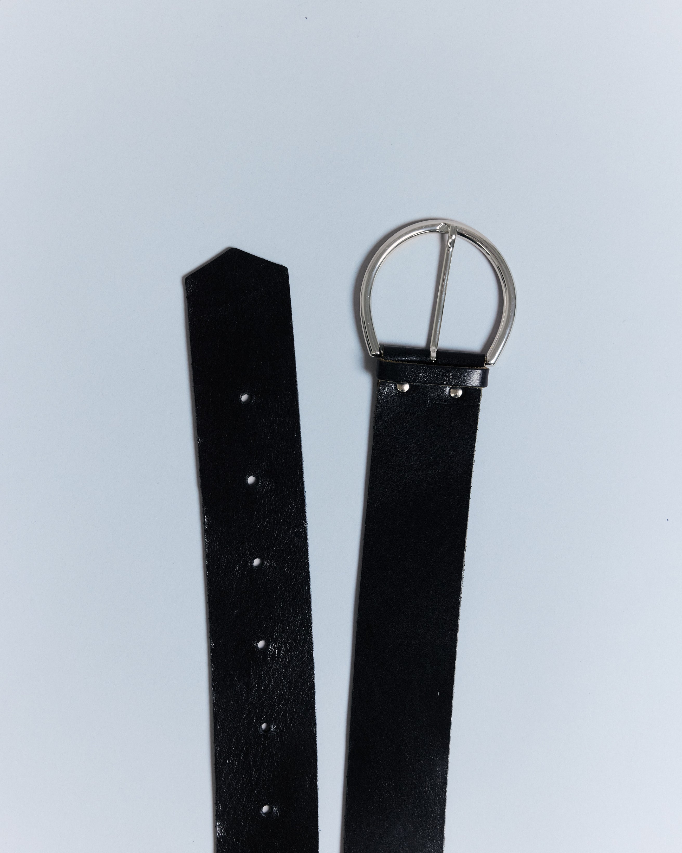 KALDA black leather belt with a silver buckle, displayed on a plain background.
